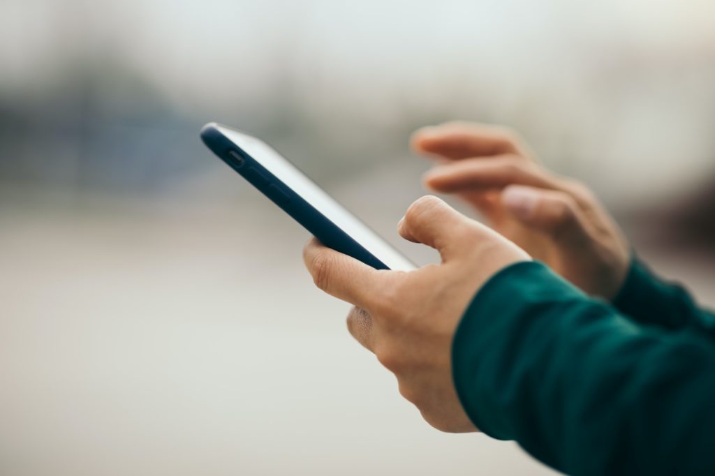 Asian woman using smartphone outdoors