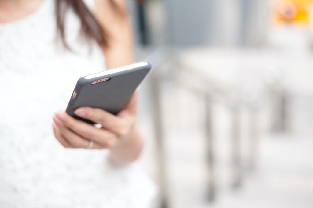 Woman sending sms on cellphone